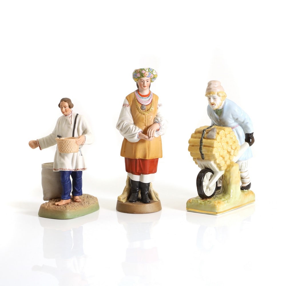 A Dmitrov State Porcelain Factory bisque porcelain figure 'Sower' and a 'Flower Girl',: A Dmitrov State Porcelain Factory bisque porcelain figure 'Sower' and a 'Flower Girl', 20th century, he is impressed '31' and she is impressed '185', both with blue printed marks, 17cm and 21cm high,