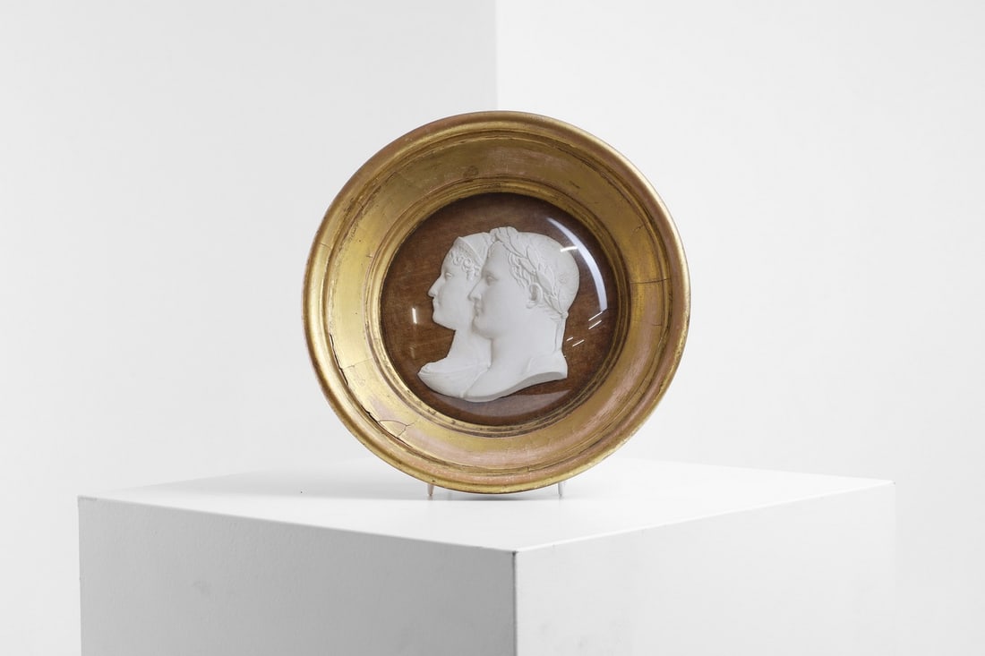 A bisque porcelain double-profile portrait,: A bisque porcelain double-profile portrait, mid-19th century, French, depicting Napoleon and Empress Marie Louise, mounted on tan velvet and in a giltwood circular frame with convex glass, 23cm diamet