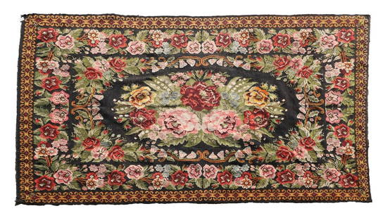 A Bessarabian flatweave wool carpet,: A Bessarabian flatweave wool carpet, 20th century, woven with dense flowers and foliate scrolls to a black ground, 400 x 260cm From the contents of Brook House, Ongar, the former home of Gillian Raffl