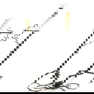 A near pair of wrought iron rush nips,: A near pair of wrought iron rush nips, with a spiral stem and a sprung holder raised on a tripod base, 51cm high and 48cm high (2) Condition Report: Converted to electricity, overpainted. Passed PAT t