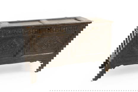 An oak coffer,: An oak coffer, early 17th century, with diamond and floral carved motifs to the two panels, 102cm wide 48cm deep 65cm high Condition Report: Carved panel with later lock and replacement keyhole. Histo