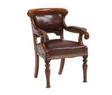 A Victorian mahogany elbow chair,: A Victorian mahogany elbow chair, the rounded top raised above leather upholstery and faceted front supports, 60cm wide 52cm deep 85cm high