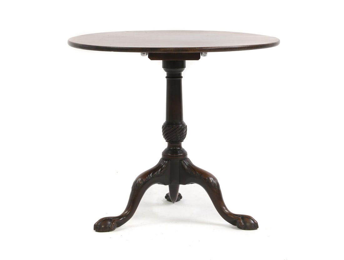 A George III mahogany tripod table,: A George III mahogany tripod table, the circular tilt top, raised on a turned column and tripod support, 78.5cm diameter 70cm high