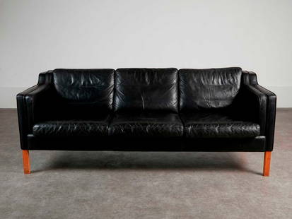 A black leather three-seater settee,: A black leather three-seater settee, c.1970s, Danish, in the manner of B&#248;rge Mogensen, 200cm wide 85cm deep 78cm high, seat 40cm high Condition Report: Fair, signed of usage. Supports fair, some