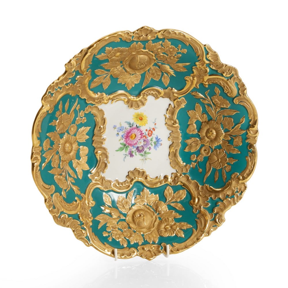A Meissen porcelain bowl,: A Meissen porcelain bowl, 20th century, relief moulded and with gilt with floral sprays, centred with an enamelled floral spray, impressed and painted marks, 31.1cm diameter Condition Report: Wear and