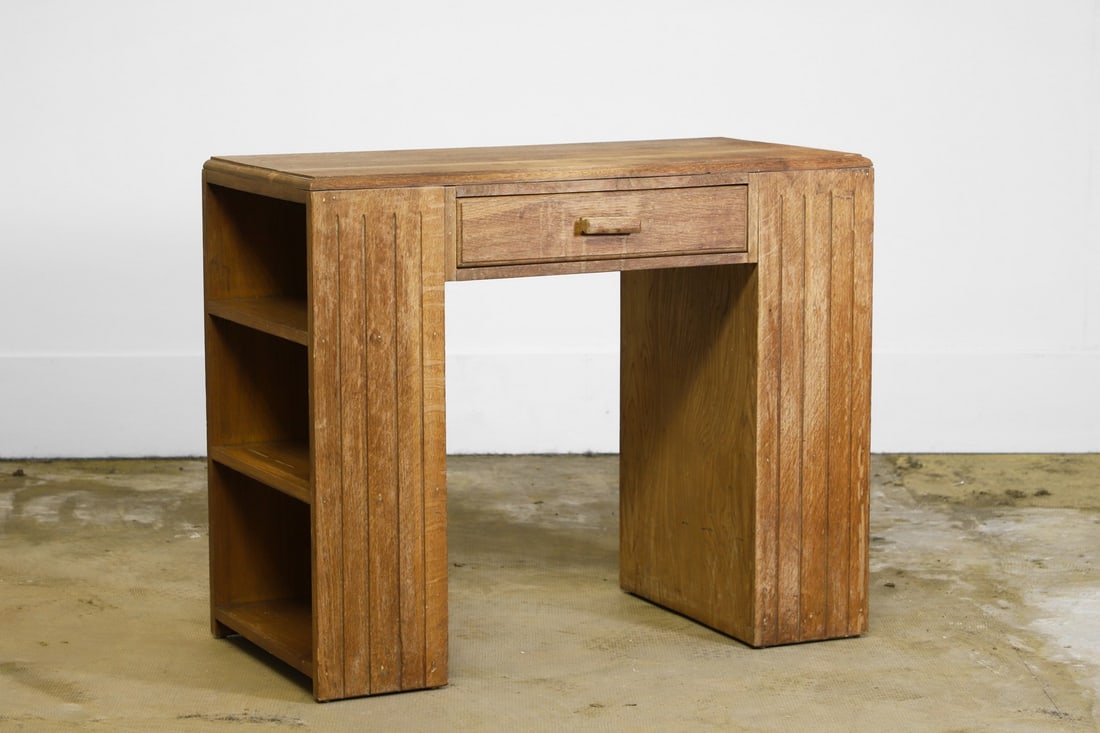 An Arts & Crafts style oak desk or console table,: An Arts & Crafts style oak desk or console table, mid 20th century, with a drawer to the centre, the fluted supports with shelves to each side, 91cm wide 41cm deep 75cm high