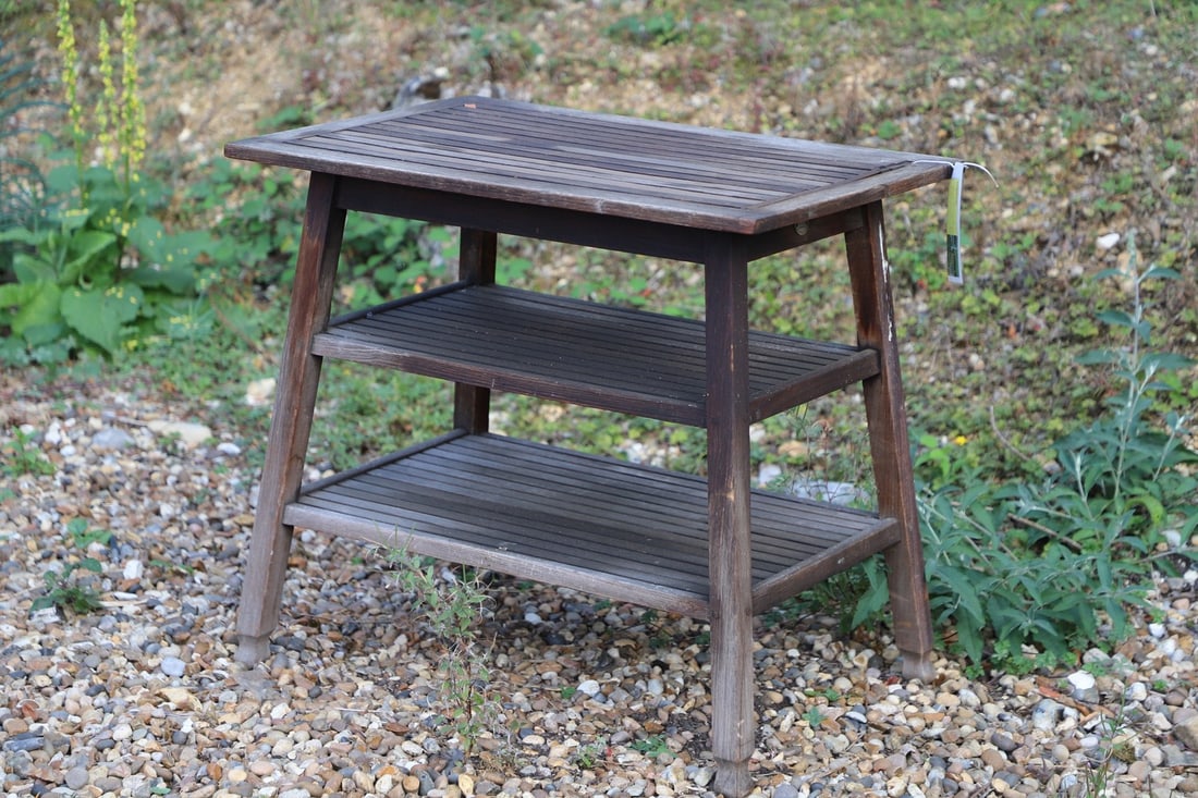 A Castles' three-tier teak table,: A Castles' three-tier teak table, designed by Castles Ship breakers, London, probably retailed by Heals, 76cm wide 50.5cm deep 69cm high