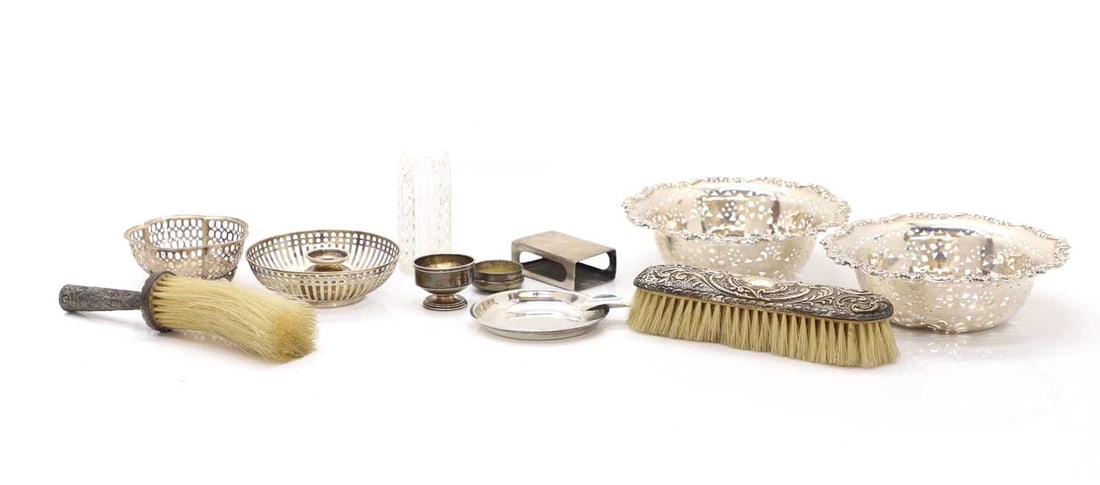 A collection of silver,: A collection of silver, variously marked, a pair of pierced silver dishes, 15.5cm, a pierced and lobed dish, another silver dish, an ashtray, a pair of salts, a matchbox sleeve, two brushes, a silver