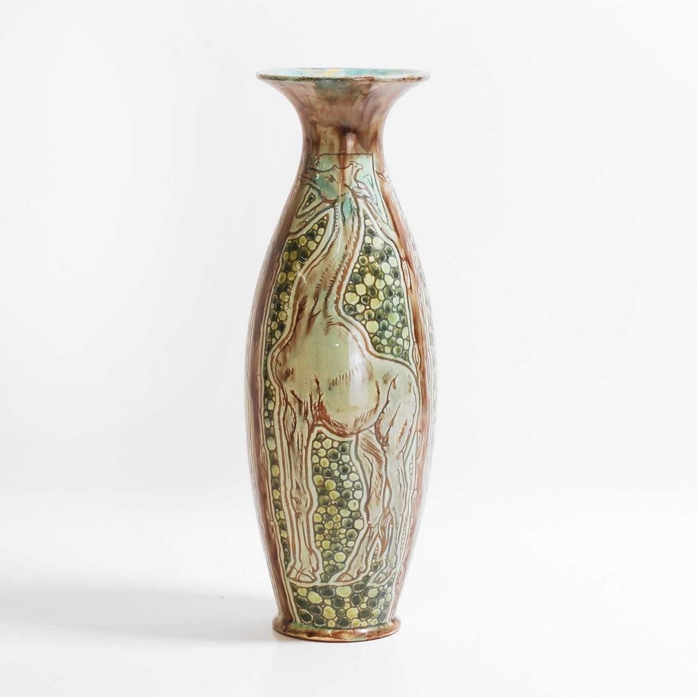 Della Robbia Pottery,: Della Robbia Pottery, a slender form vase, c.1899, incised with three panels of giraffes, feeding off the trees, forming the borders, on a 'bubble' ground, marked with Galleon, 'CDR 609', with later i