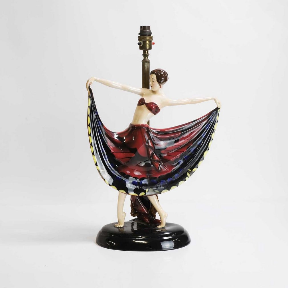 Attributed to Josef Lorenzl (Austrian, 1892-1950),: Attributed to Josef Lorenzl (Austrian, 1892-1950), a Goldscheider pottery lamp, c.1930, Austrian, modelled as a lady with her arms outstretched supporting her dress, complete with a lampshade, printed