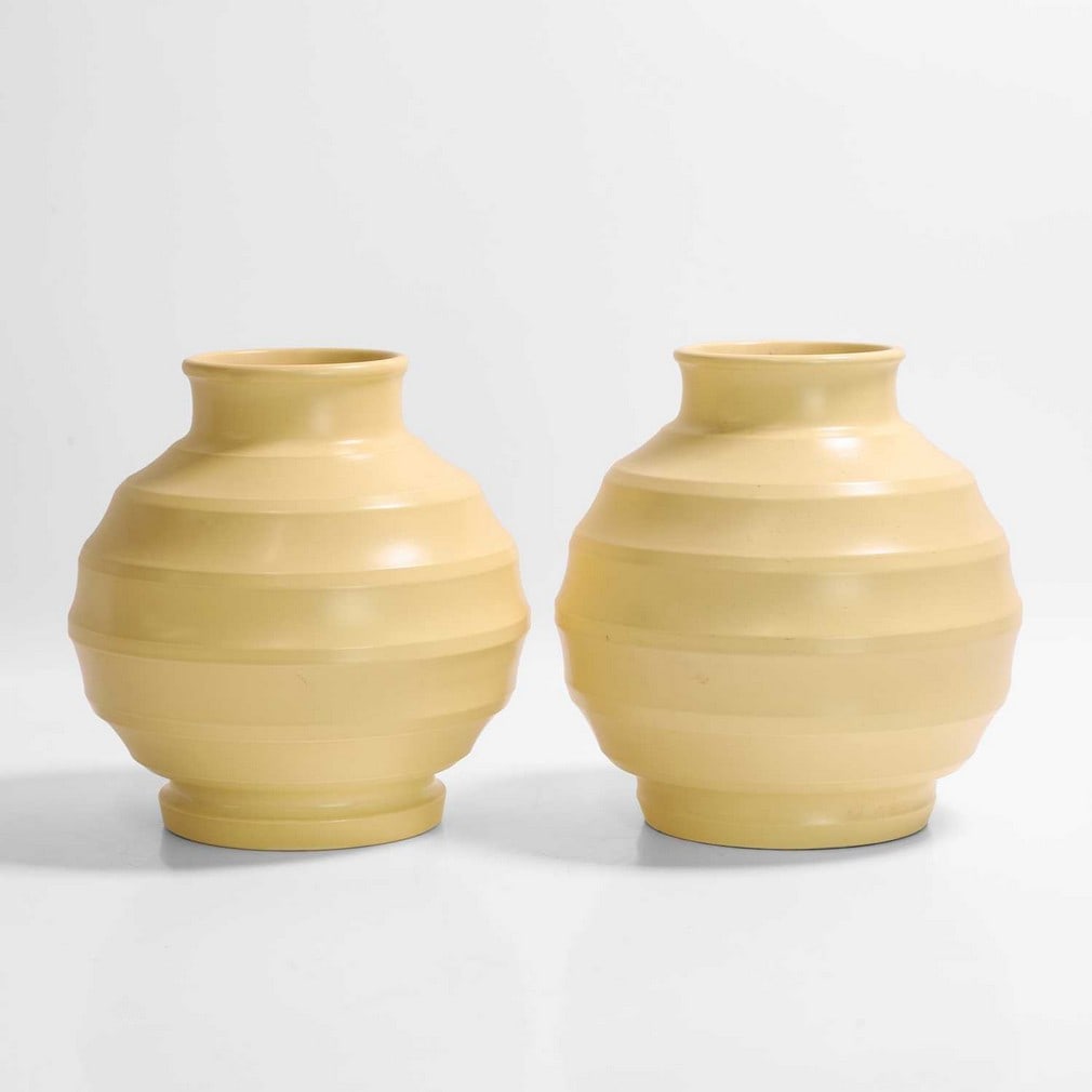 Keith Murray (1892-1981) for Wedgwood,: Keith Murray (1892-1981) for Wedgwood, two matt straw globular vases, one unmarked, the other printed 'Wedgwood of Etruria & Barlaston KM Made in England', 18.5cm high (2) Provenance: A private collec