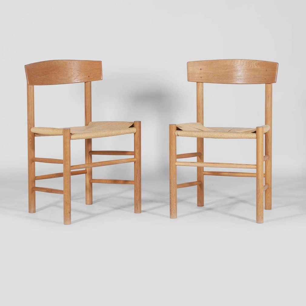 Børge Mogensen (Danish, 1914-1972) for Fredericia,: Børge Mogensen (Danish, 1914-1972) for Fredericia, a pair of 'J39' dining chairs, of recent manufacture, designed 1947, each oak frame with a band back and a wicker seat, 48cm wide 42cm deep 77cm