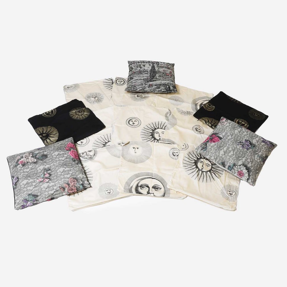 Piero Fornasetti (Italian, 1913-1988),: Piero Fornasetti (Italian, 1913-1988), a group of eleven 'Sun' cushion covers, of recent manufacture, cut in cotton, nine in cream and black, and two in black and gold, together with three further cus