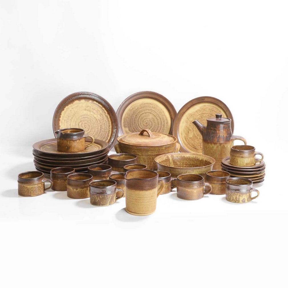 Emmanuel Cooper (1938-2012),: Emmanuel Cooper (1938-2012), a tea service, stoneware with brown and yellow glaze, comprising a lidded tureen, two bowls, one lidded jug, two further jugs, ten dinner plates, seven side plates and twe