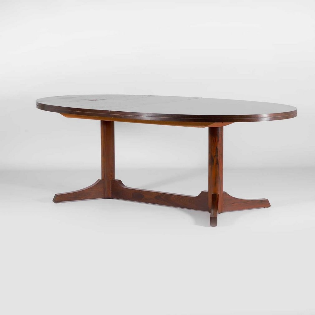 § Robert Heritage (1927-2008) for Archie Shine,: § Robert Heritage (1927-2008) for Archie Shine, an rosewood extending dining table, c.1970s, the oval top supported on two columns united by a stretchered base, 202cm wide extended 247cm wide 109