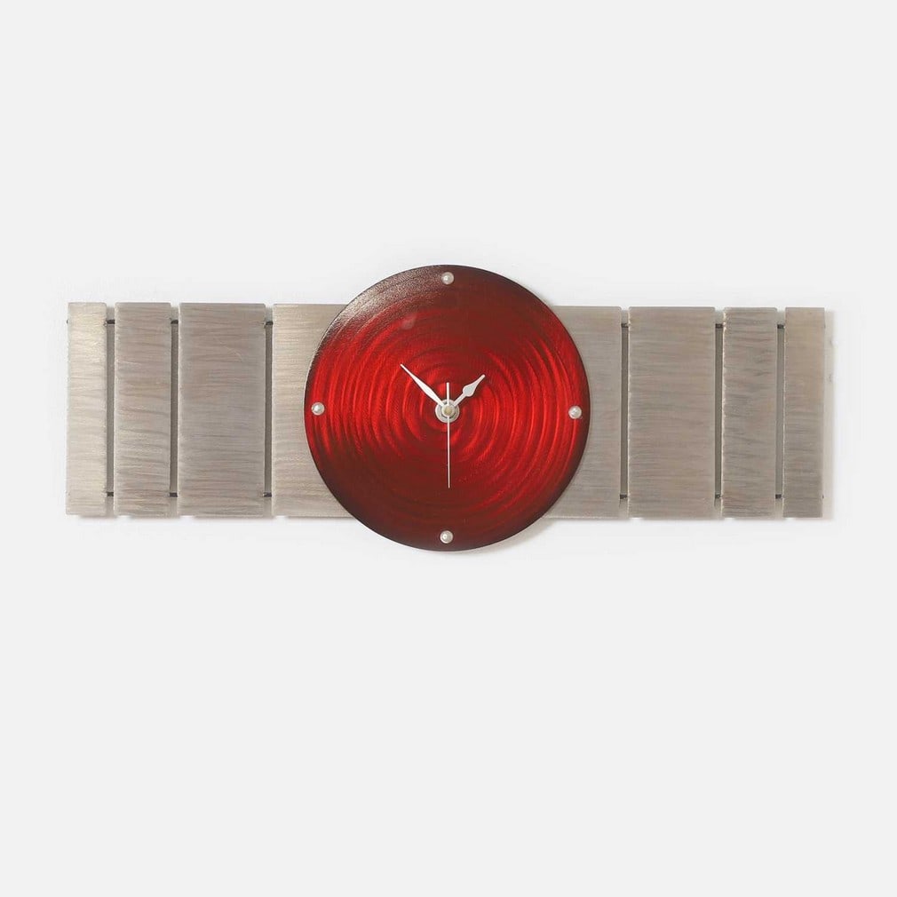 ▲ Jake Howard (b.1969),: ▲ Jake Howard (b.1969), a metal wall clock, the red face over a slatted back, 20 x 61cm Condition Report: This item is not tested and the movement does not function. Otherwise appearing in good