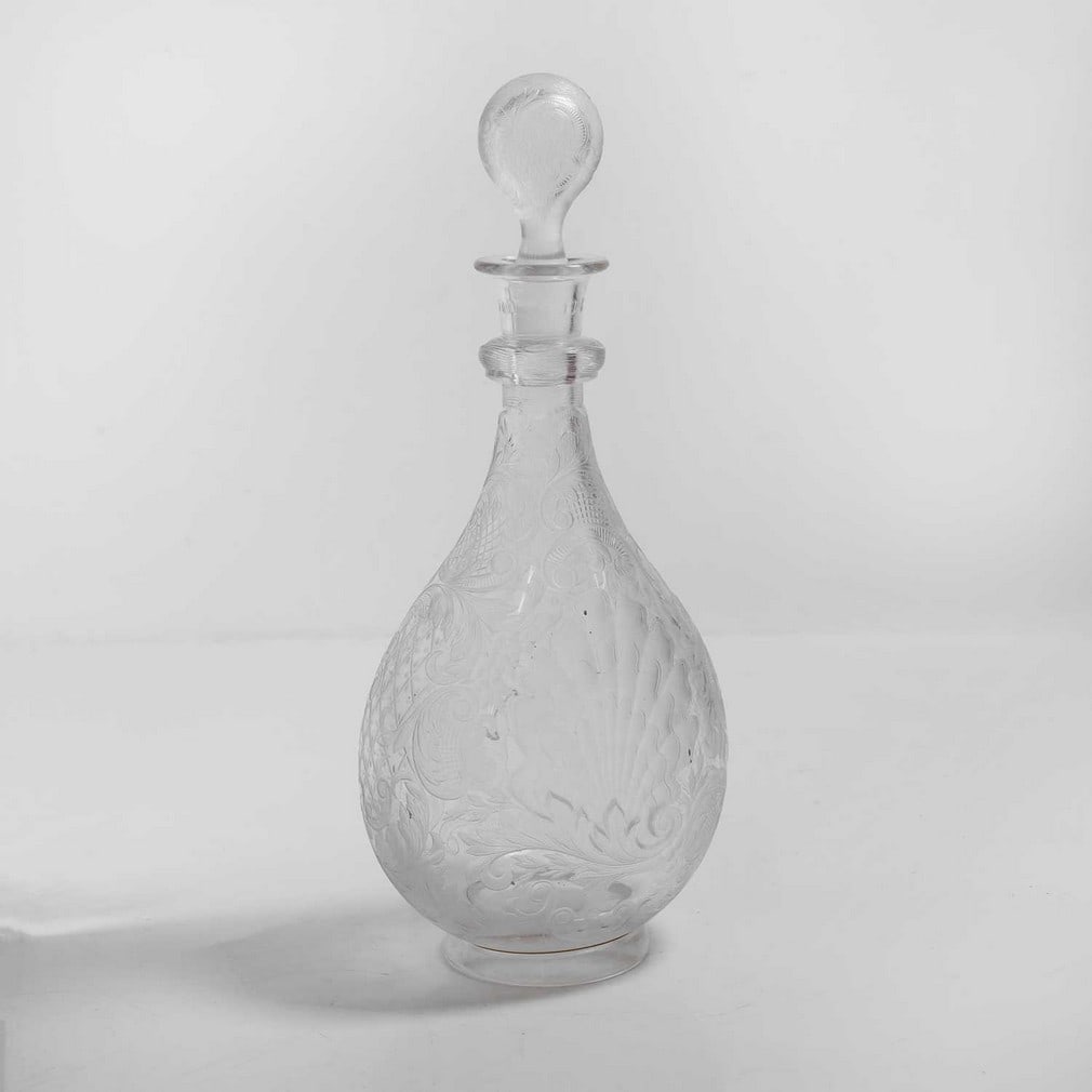 An intaglio cut 'Rock Crystal' glass decanter,: An intaglio cut 'Rock Crystal' glass decanter, c.1890, Stourbridge, in the manner of Thomas Webb & Sons or Stevens & Williams, of compressed globe and shaft form, deeply cut and engraved with two shel