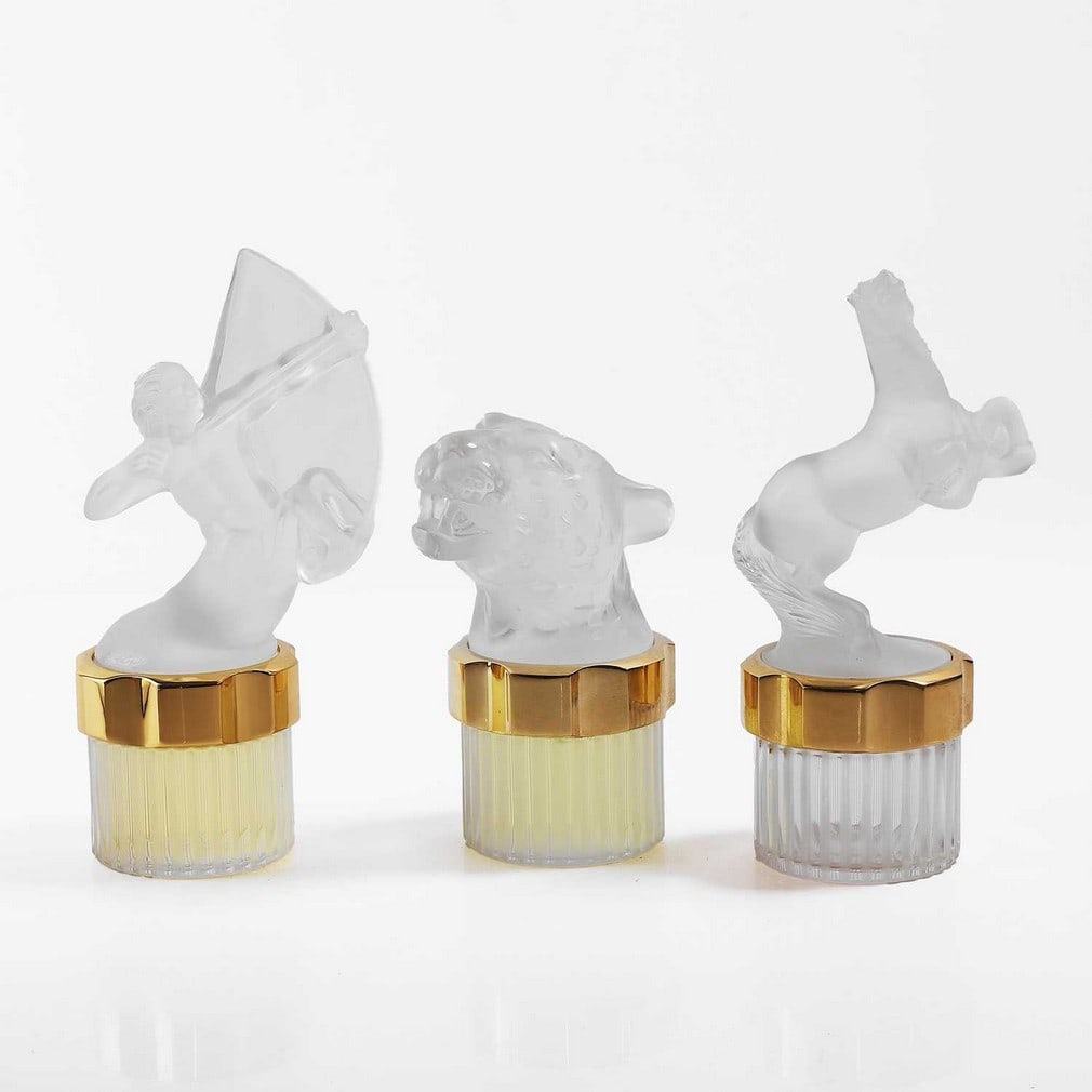 A group of limited Lalique factice scent bottles,: A group of limited Lalique factice scent bottles, of recent manufacture, comprising: 'Equus', 19.6cm high, 'Sagittaire', 20.3cm high, and 'Panthere', 15cm high, engraved signatures (3) Condition Repor