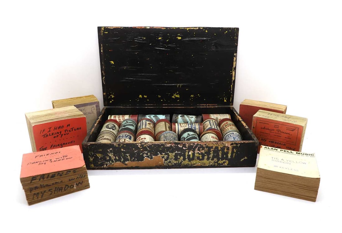 Eighteen phonograph cylinders and six organ books,: Eighteen phonograph cylinders and six organ books, the cylinders, in a painted pine box, the organ books, printed and hand-inscribed, to include 'I LIKE MUSIC, FARMERS BOY', 'DANCING WITH MY SHADOW',