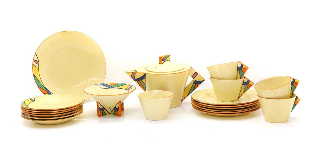 A Clarice Cliff 'Bignou' tea service,: A Clarice Cliff 'Bignou' tea service, 20th century, to include a teapot, 24cm wide, five cups, 13cm wide, six saucers, 17cm diameter, together with eight plates, 20-23.5cm diameter, and a sugar bowl,