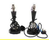 A pair of facet cut black and clear glass lamps,