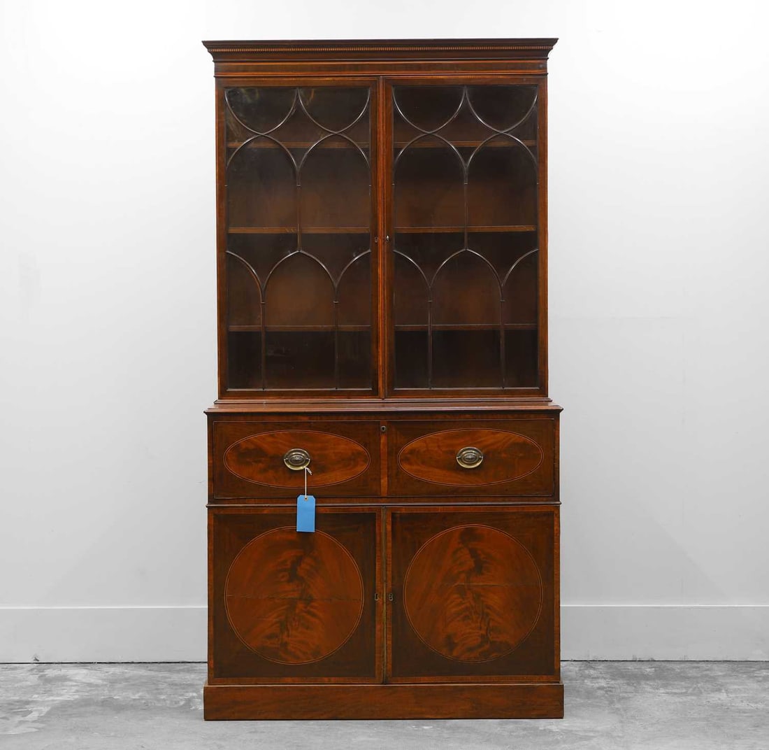 A George III mahogany and tulipwood banded secretaire bookcase,: A George III mahogany and tulipwood banded secretaire bookcase, late 18th century, the dentil inlaid cornice above a plain freize and a pair of astragal glazed doors enclosing shelves, the lower secti