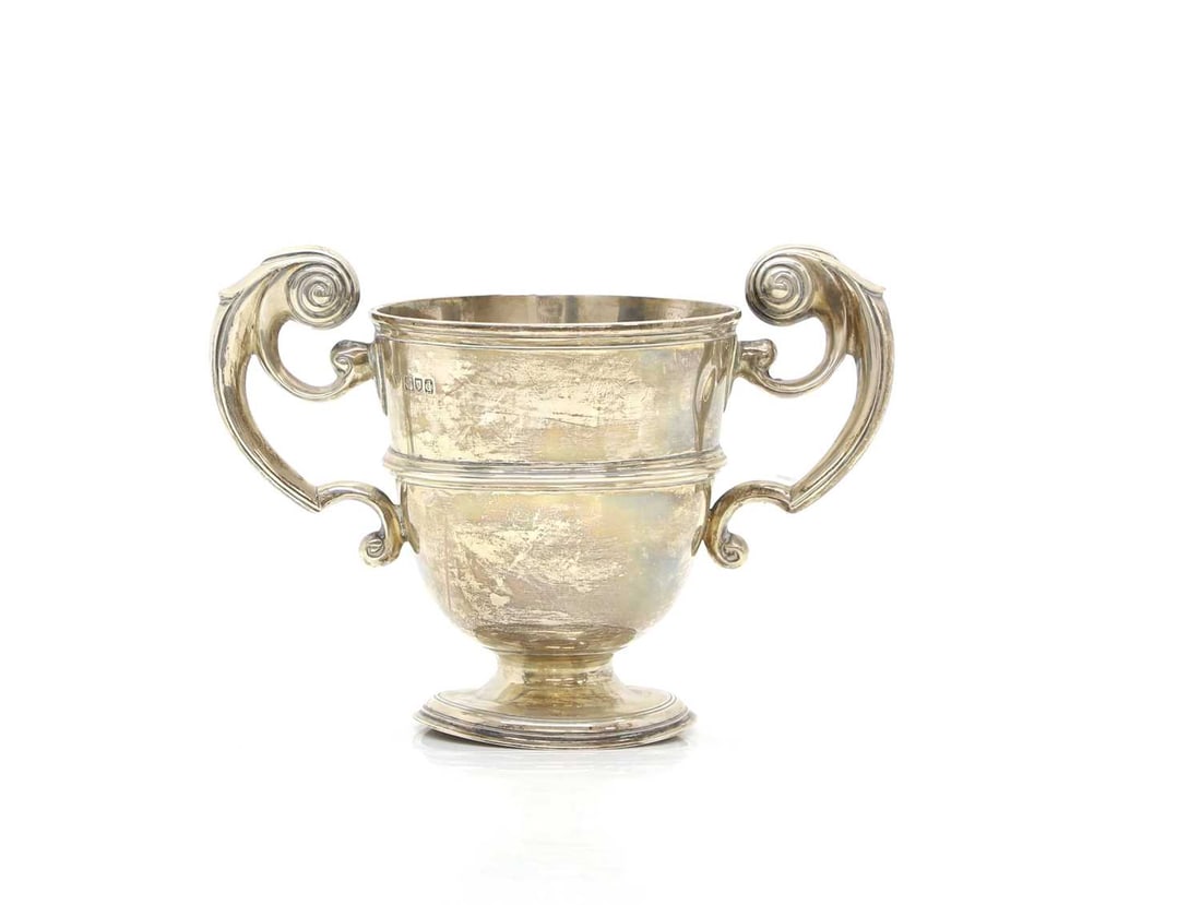 A twin handled silver trophy cup,: A twin handled silver trophy cup, by Charles Stuart Harris, London, 1899, with scrolling handles,15.5cm high15.9ozt 15.9ozt