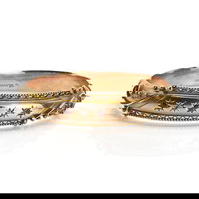 An Edwardian 9ct gold garnet and rose cut diamond set hinged bangle,: An Edwardian 9ct gold garnet and rose cut diamond set hinged bangle, star set with alternating round cut rubies and rose cut diamonds, to a hollow hinged bangle with applied wire scrolls and wire twis