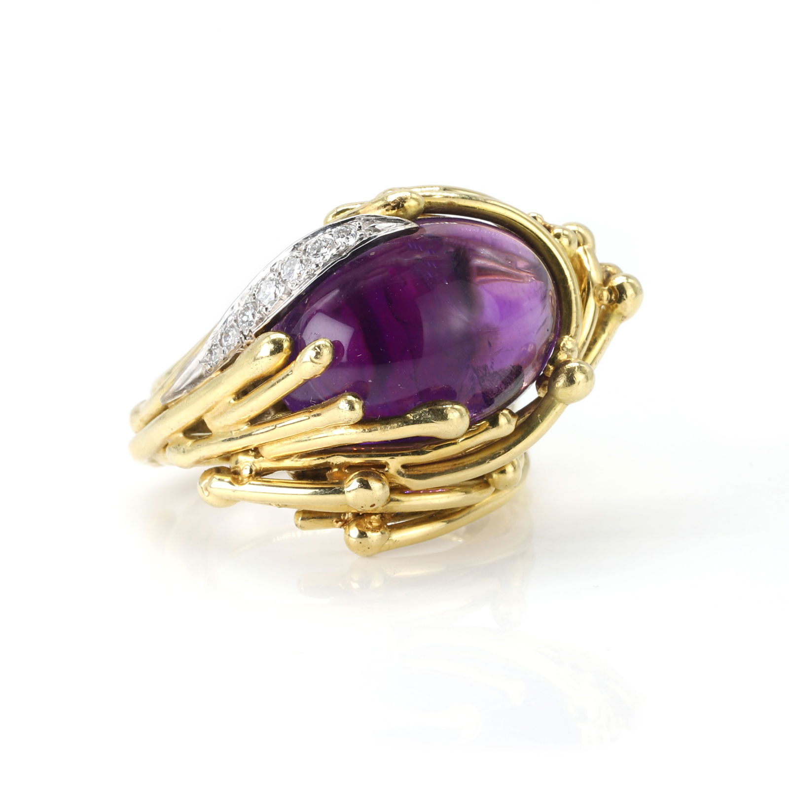 An amethyst and diamond ring, by Grima: An amethyst and diamond ring, by Grima the oval cabochon amethyst to a wraparound gallery and hoop, formed by polished gold 'twigs', accented with a line of pavé diamonds, signed Grima, 21.00g, i