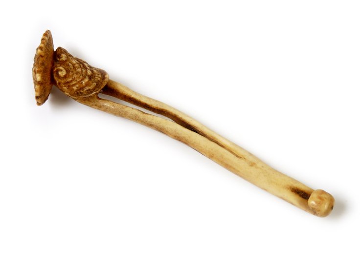 A stag antler Sashi Netsuke, the terminal carved with r: A stag antler Sashi Netsuke, the terminal carved with rui fungus, signed Tani, 13.5cm