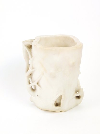 An unusual white marble Brush Pot, probably 18th centur: An unusual white marble Brush Pot, probably 18th century, in the form of a gnarled stump, growing with magnolia flowers, minor chips, 14cm For a blanc de Chine magnolia brush pot or water vessel, poss