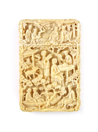 A Canton ivory Card Case, c.1830, well carved with figu: A Canton ivory Card Case, c.1830, well carved with figures taking tea in a garden and looking at a dog, others sailing by at the base, lid edge crack repaired and hole, 8.3cm