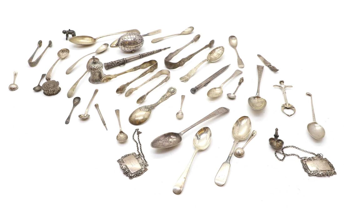 A collection of silver flatware and trinkets,: A collection of silver flatware and trinkets, to include a pair of tongs, by Chawner & Co (George William Adams), London,1863,15.8cm long, a silver spoon marked 'sterling' and inscribed 'ADMINSTR