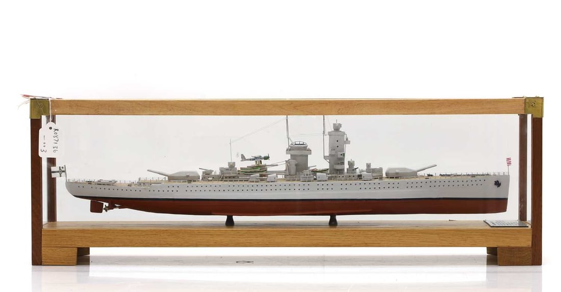 A model of HMS Dreadnought (1905): A model of HMS Dreadnought (1905) 2016, handbuilt and painted, with an inscribed plaque, in an oak glazed case, 72cm wide 16cm deep 37cm high Condition ReportPlease see additional images.