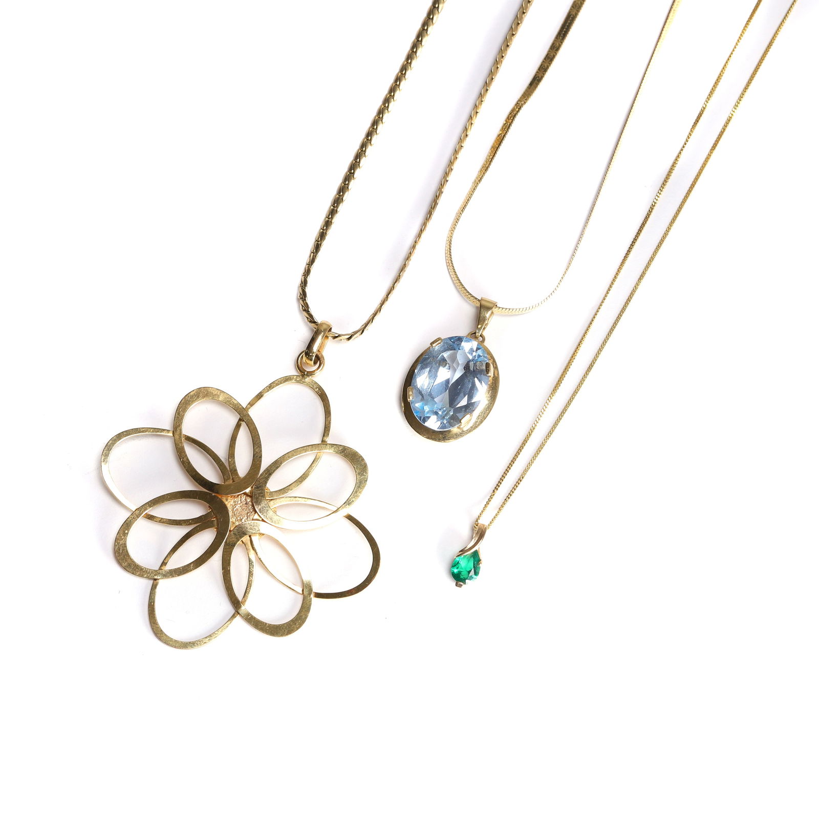 A group of three pendant necklaces,: A group of three pendant necklaces, comprising a blue synthetic spinel single stone pendant, 27mm long, stamped 750, tested as approximately 18ct gold, suspended by a 9ct gold herringbone link chain,