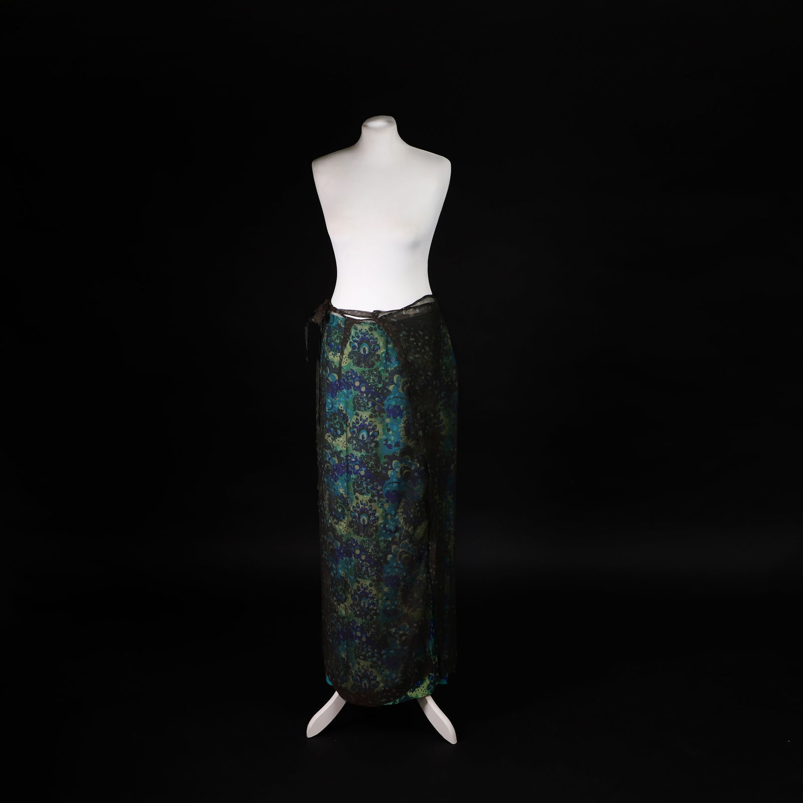 A Dries Van Noten layered skirt: A Dries Van Noten layered skirt c.1997, designed by Dries Van Noten for the spring/summer 1997 collection, cut in blue and green patterned silk, with two side splits, with a central zip closure to the