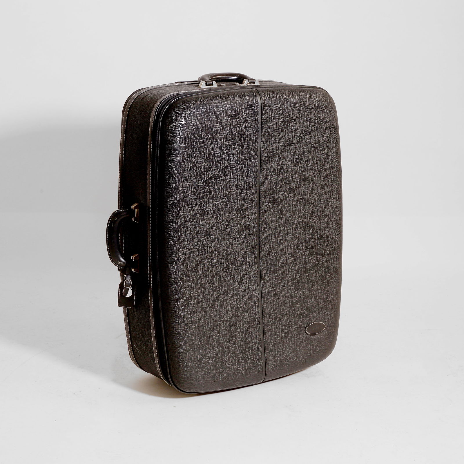 A Mulberry black scotch grain hard-sided suitcase,: A Mulberry black scotch grain hard-sided suitcase, of recent manufacture, with two wheels, retractable handle and top handle, iconic Mulberry check interior, with luggage tag, clochette, padlock and k