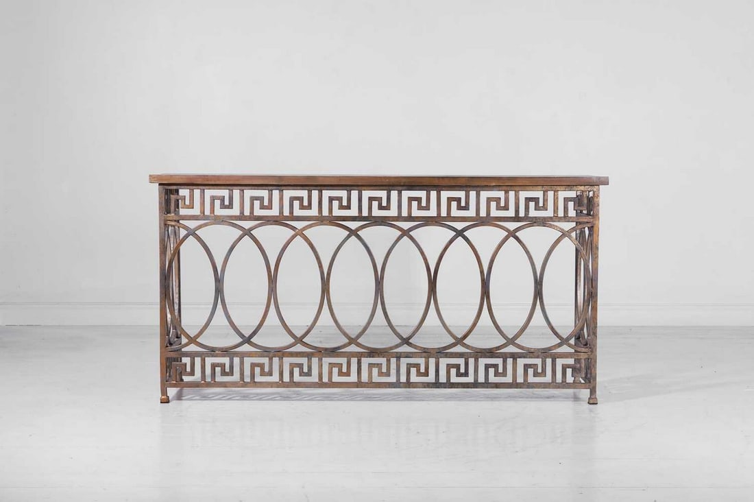 A neoclassical gilt-metal and wooden console table by OKA,: A neoclassical gilt-metal and wooden console table by OKA, of recent manufacture, the rectangular top above a pierced frame with Greek-key decoration, raised on short square feet, with a verdigris fin