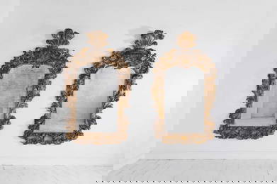 A pair of George II giltwood pier mirrors attributed to Matthias Lock,