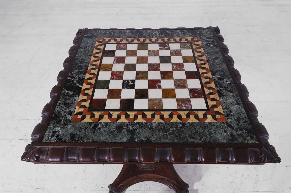 A William IV rosewood and specimen marble games table,: A William IV rosewood and specimen marble games table, c.1835, attributed to Gillows, the square chequerboard top inlaid with various hardstones, within a geometric border and a wide band of serpentin