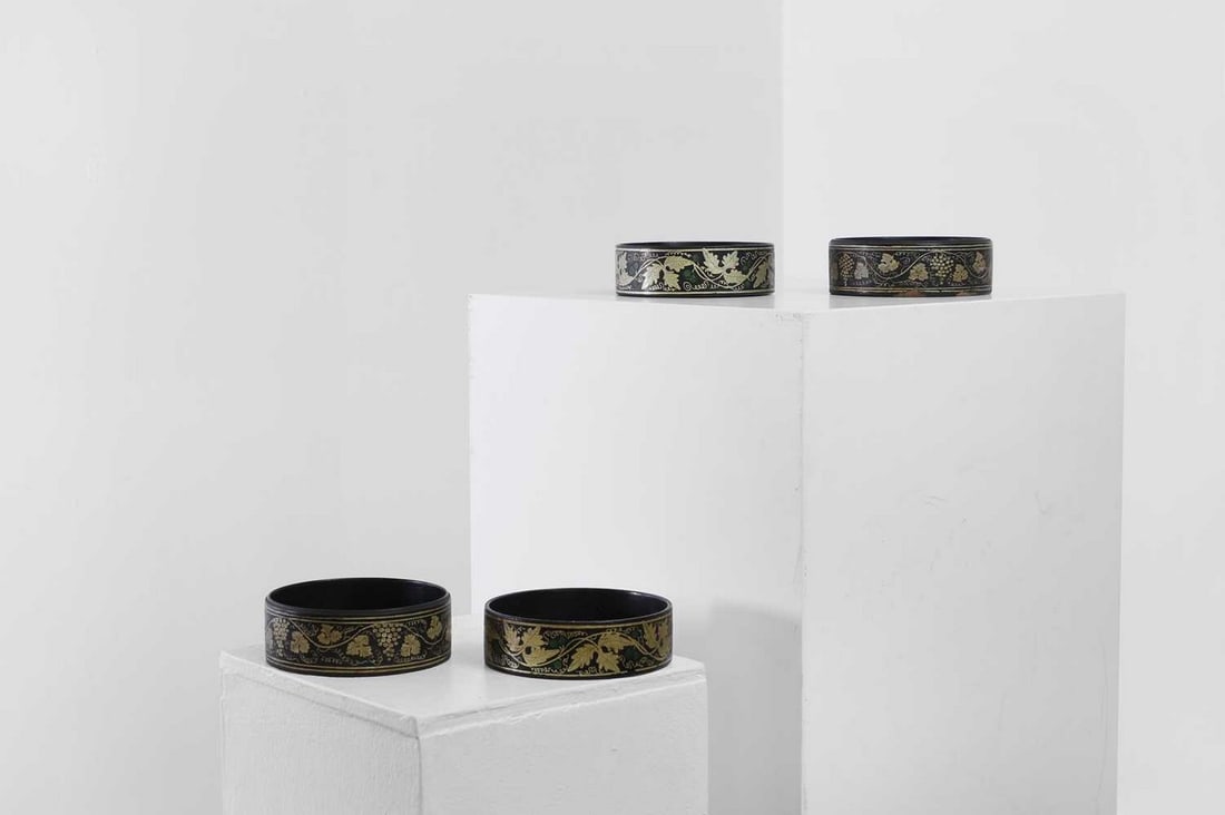 Two pairs of Regency papier mâché coasters,: Two pairs of Regency papier mâché coasters, early 19th century, each decorated with gilt foliage, 12cm diameter (4) Provenance: An East Anglian Private Collection.