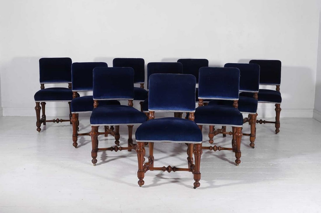A set of ten Victorian walnut dining chairs,: A set of ten Victorian walnut dining chairs, c.1870, each upholstered in royal-blue velvet fabric, on fluted and turned supports, 50cm wide 55cm deep 82cm high (10)