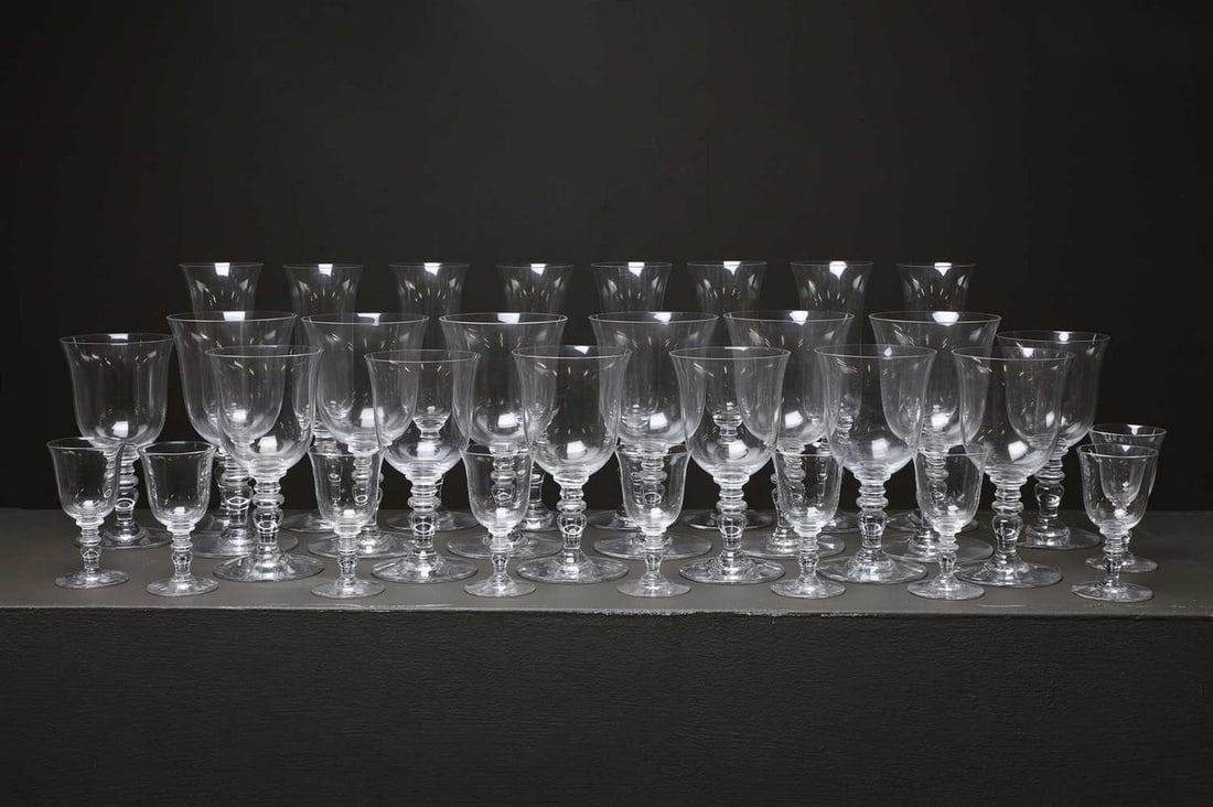 A Baccarat crystal glass suite,: A Baccarat crystal glass suite, 20th century, French, in the 'Provence' pattern, comprising: 8 champagne flutes, 19cm high, 6 water goblets, 16cm high, 8 wine glasses, 14.5cm high, and 9 cordial glass