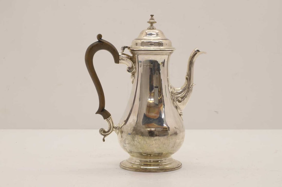 A silver coffee pot,: A silver coffee pot, by Charles Stuart Harris, London, 1898, George III style, with scrolled wooden handle and acorn finial, 24.5cm hightotal 23.2ozt total 23.2ozt