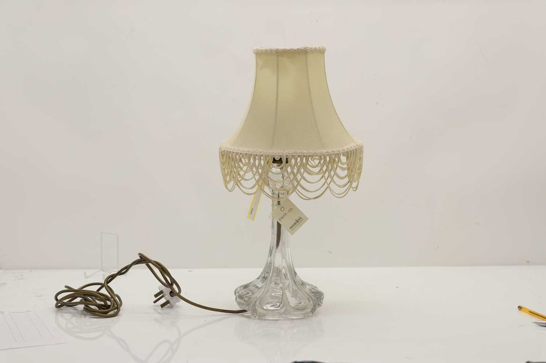 A Baccarat moulded glass lamp,: A Baccarat moulded glass lamp, late 19th to early 20th century, of lobed form, relief moulded marks,26cm high to fitting Condition Report We cannot guarantee th