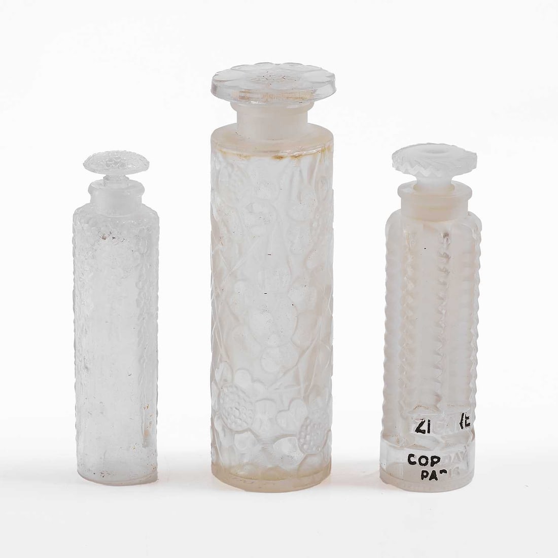 René Lalique (French, 1860-1945),: René Lalique (French, 1860-1945), a 'Tzigane' scent bottle, designed for Corday in 1937,9.8cm high,a 'Cinq Fleurs' scent bottle, designed for Forvil in 1924,11.8cm high, anda 'Chypre' scent bott