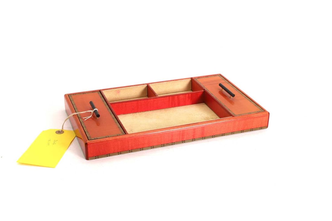 An Elie Bleu 'Fruit' stained sycamore jewellery tray 20th century: An Elie Bleu 'Fruit' stained sycamore jewellery tray 20th century the stained reddish orange ground with geometric design border, the interior sheathing in goats' suede, with three open compartments
