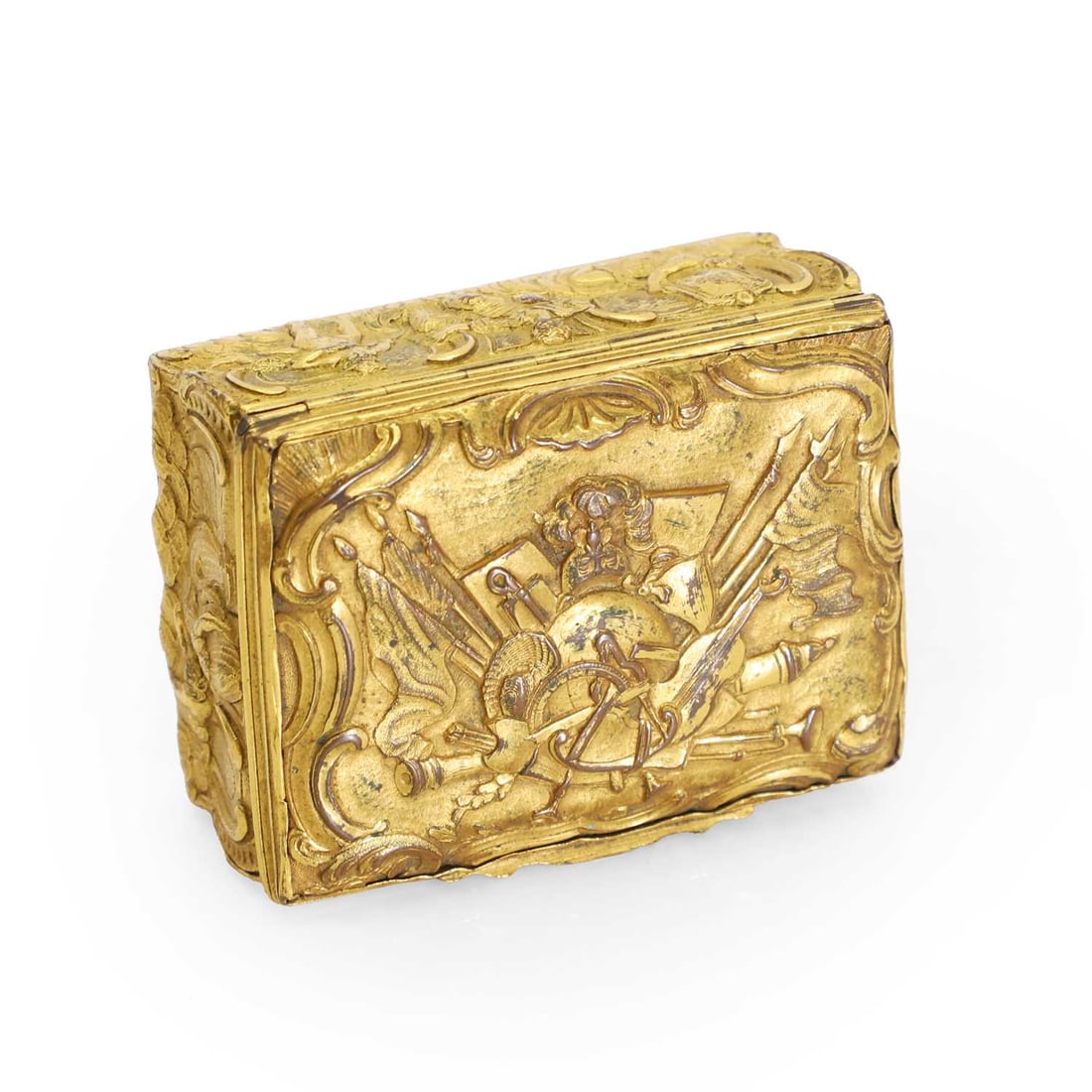 An ormolu snuff box 18th century: An ormolu snuff box 18th century With chased decoration of musical instruments amongst spears, helmets, and flags 7.5cm wide, 5.5cm deep, 3.6cm highCondition Report: The hinge works and the box opens