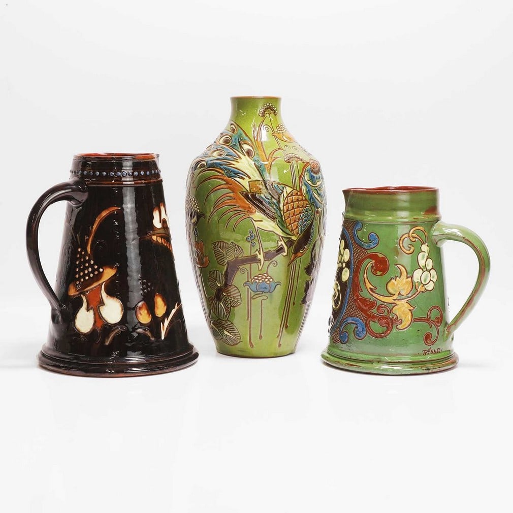 C H Brannam Pottery A brown jug: C H Brannam Pottery A brown jug Dated 1890, by James Dewdney, incised with a spray of foliage, with a jewelled band to the rim, incised 'CH Brannam Barum, with artist's monogram 'JD', and numbered '13