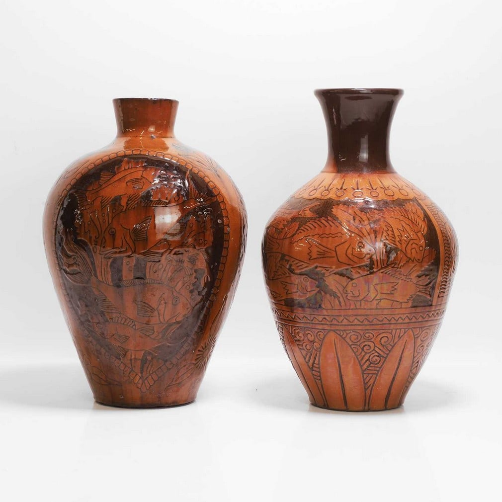 C H Brannam Pottery Two similar vases: C H Brannam Pottery Two similar vases One by James Dewdney, with a two-tone slip glaze, with incised panels of fish opposite birds, incised 'CH Brannam Barum ware and further indistinct marks', the ot